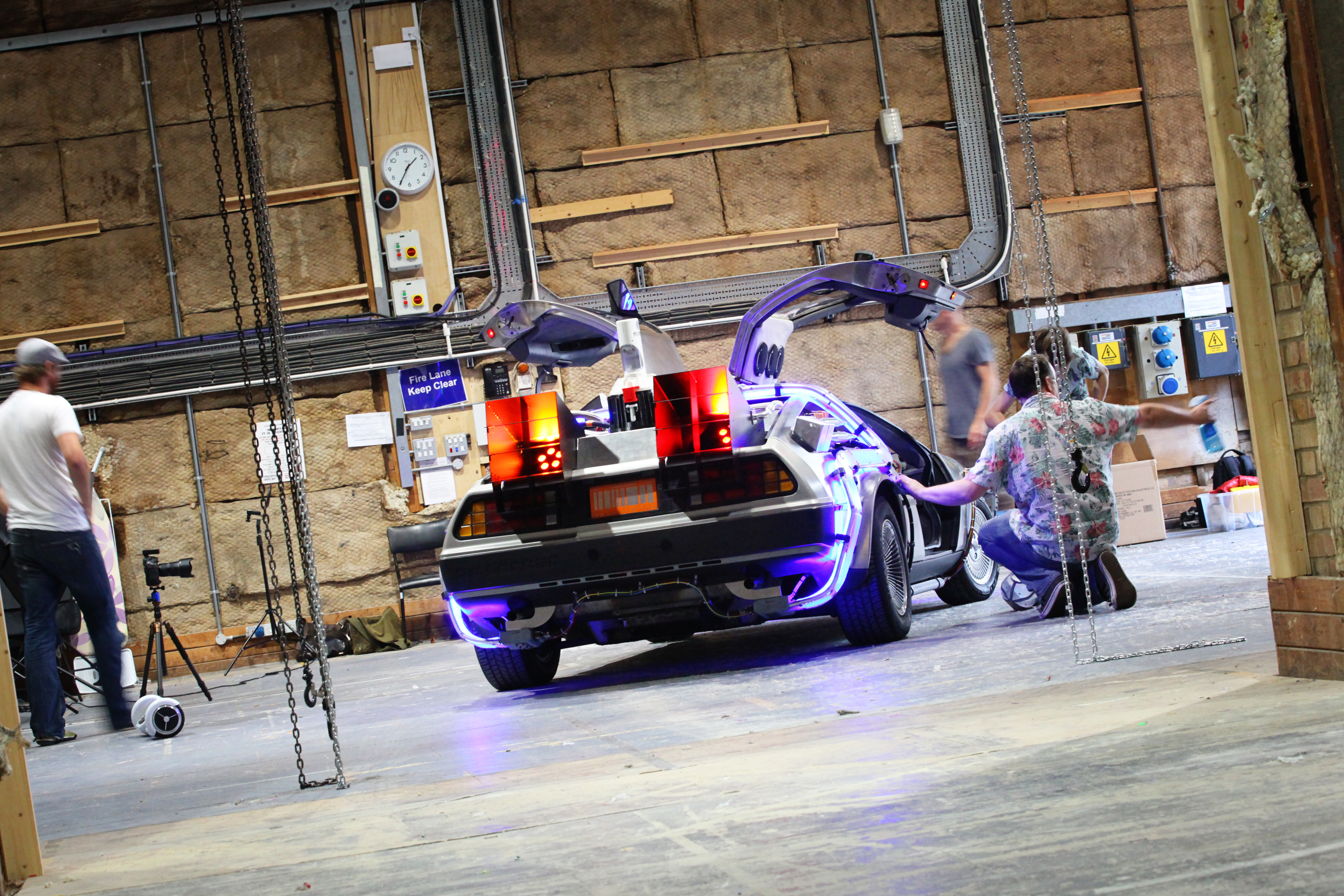 Behind the scenes studio setup with DeLorean and crew