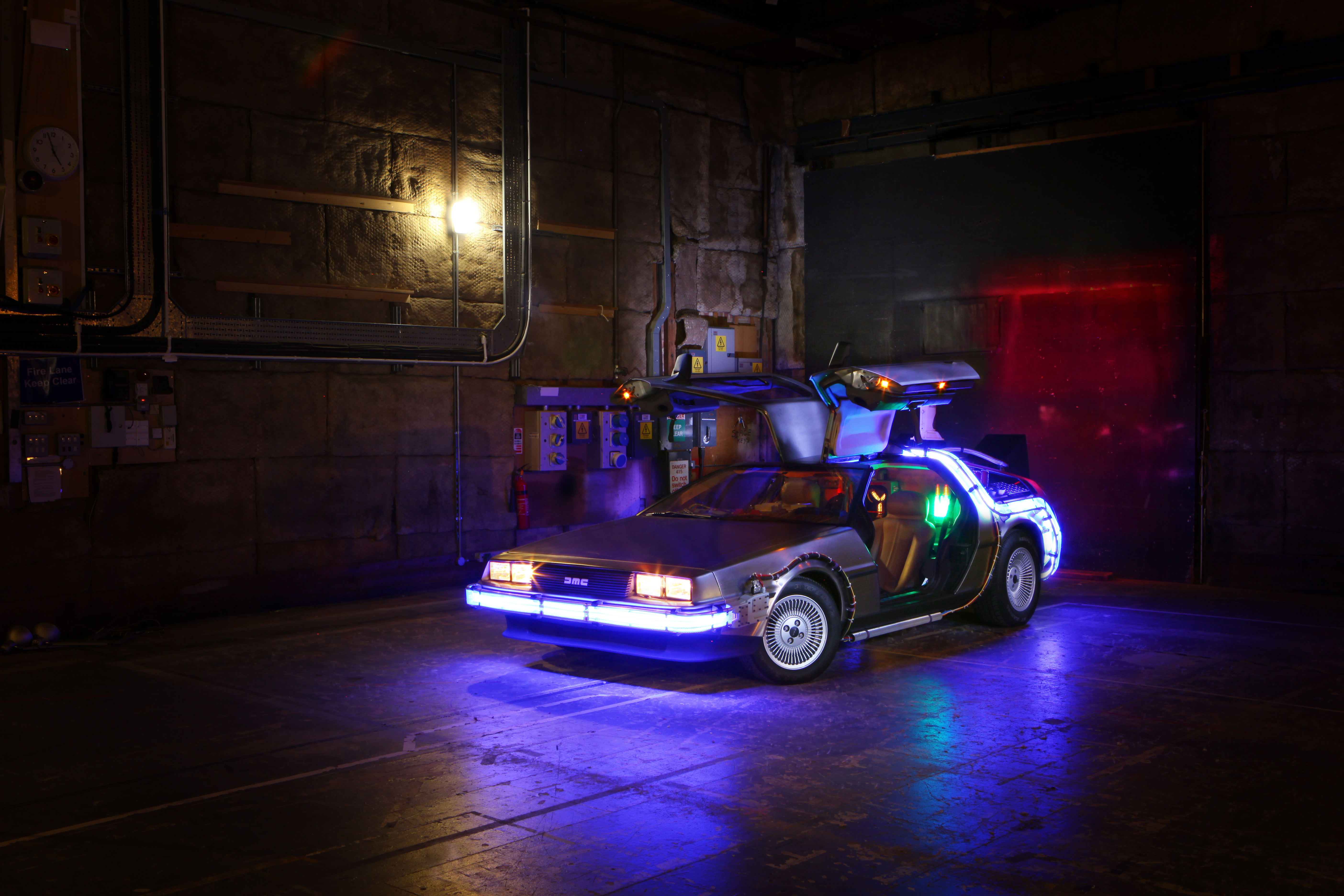 Back to the Future DeLorean Time Machine with gullwing doors open and dramatic blue lighting
